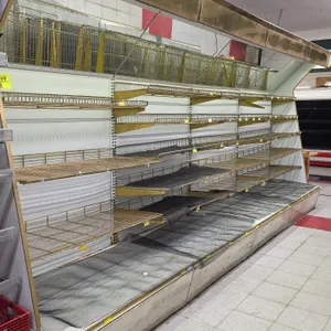 24'L of Hussmann lighted wall shelving. Features 92"H uprights, 31"D base deck, adjustable wire cantilever shelves, angled mirror canopy, and integrat