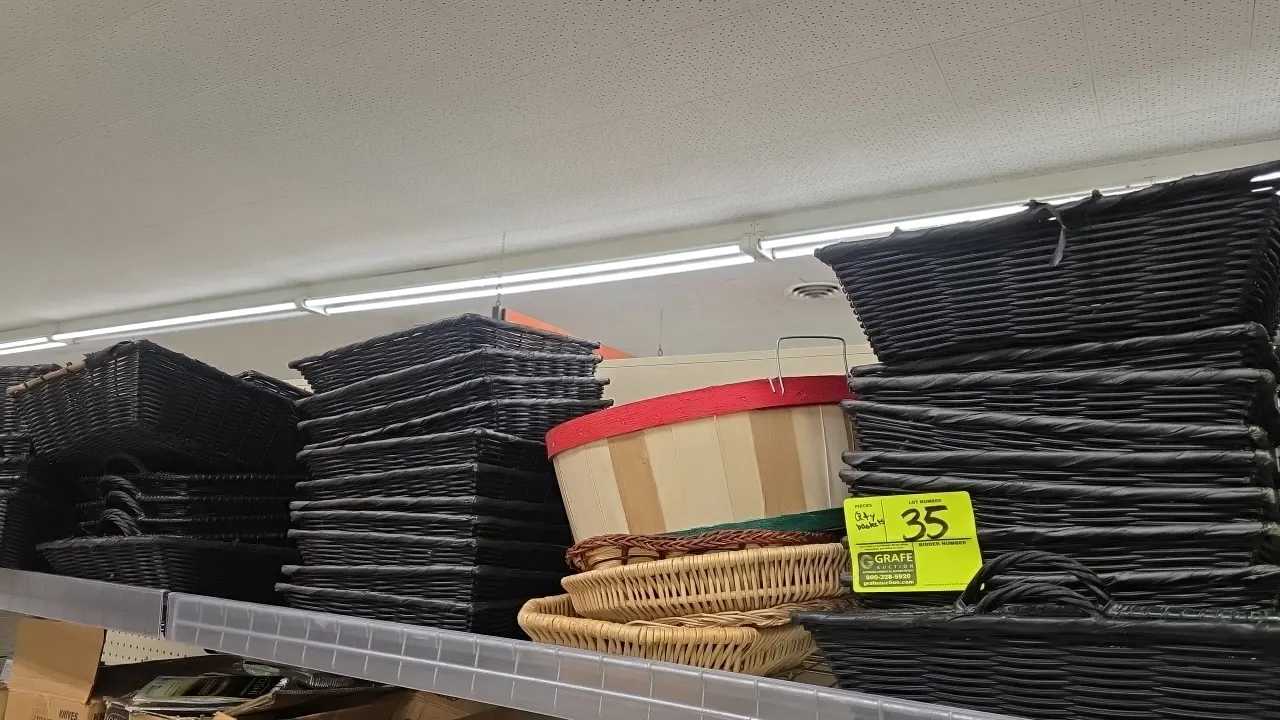Assorted retail display baskets. Includes black woven rectangular baskets and handled trays in various sizes, natural woven round display baskets, and