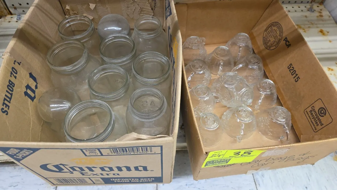 Assorted glassware lot. Includes glass punch cups with embossed grape and leaf motif, clear glass fruit and canning jars, and cylindrical glass light