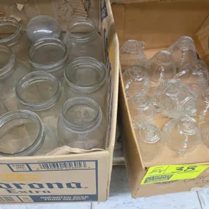 Assorted glassware lot. Includes glass punch cups with embossed grape and leaf motif, clear glass fruit and canning jars, and cylindrical glass light 