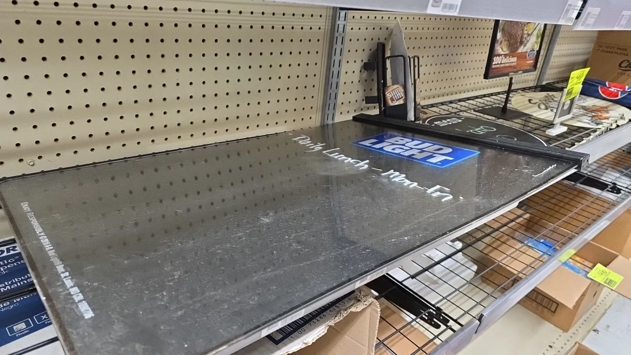 Assorted advertising signage and display collection. Includes Bud Light dry-erase menu board, rolled Pepsi banners, Star Ranch Angus framed counter si
