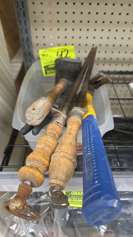 Assorted hand tools and sharpening steels. Includes (2) honing steels with turned wood handles and hanging rings, (1) mallet with wood handle, (1) Reg