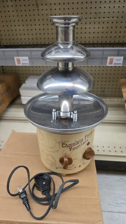 Nostalgia Electrics CFF-884 Old Fashioned chocolate fondue fountain. Features a 3-tier stainless steel tower, stainless steel reservoir basin, and dua