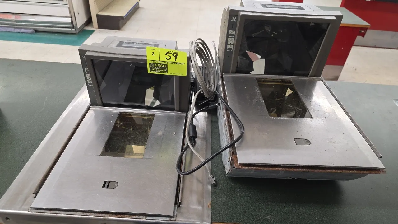 NCR 7875-2000 bi-optic scanner scales. Features stainless steel weigh platters, horizontal and vertical scan windows, and integrated scales. Scale cap