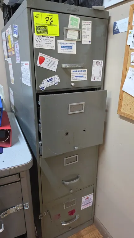 Invincible 4-drawer vertical file cabinet. Features metal construction, integrated label holders, and pull handles. Note: Second drawer is missing its