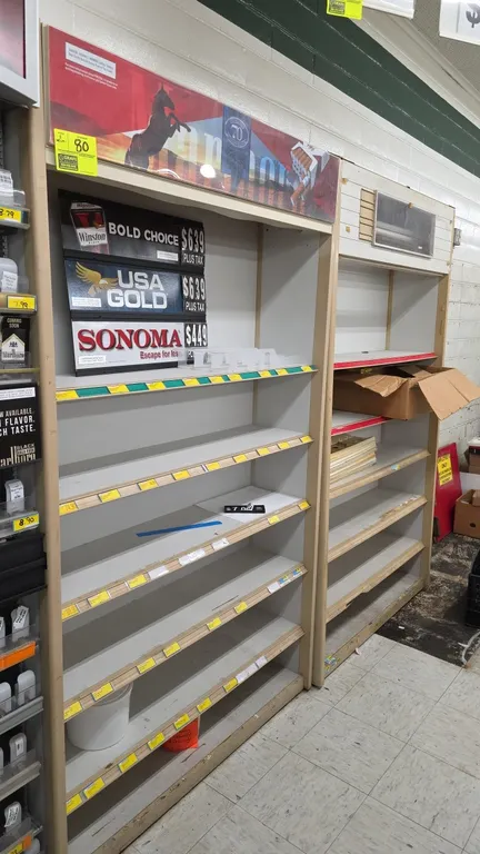Tobacco merchandiser shelving displays. Features multi-tier shelving with price tag channel molding, upper header signage frames, and wood-tone trim.