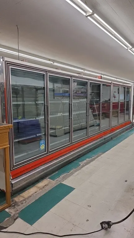 Hussmann RHFA-5LU and RHFA-3LU frozen food glass doors. Features adjustable wire shelving, interior lighting, and red accent trim. Electrical: 120V, 6
