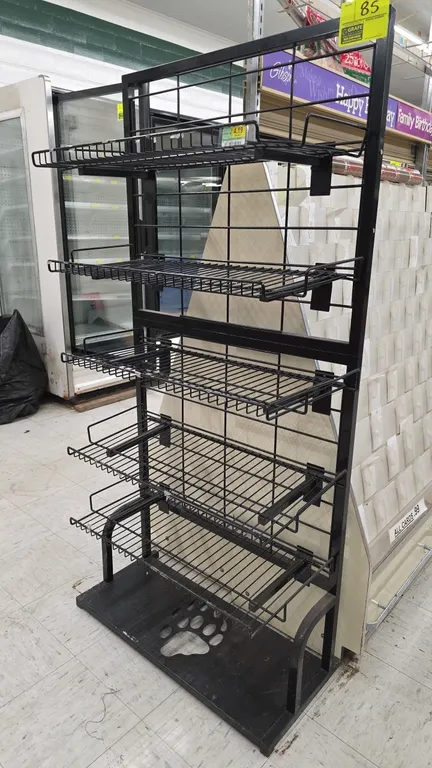 Metal merchandiser display rack. Features black metal frame with wire grid backing, (5) adjustable wire shelves, and a solid base with a paw print cut