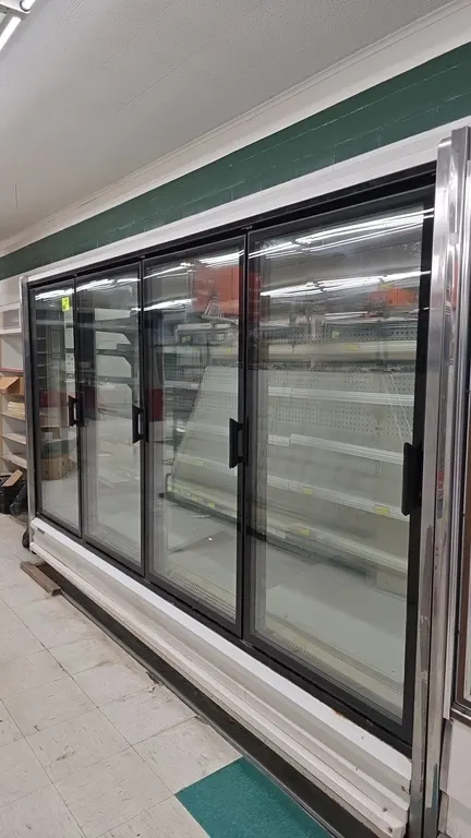1994 Hussmann NRFU4 U frozen food glass doors. Features solid metal shelving with price tag molding and interior lighting. Electrical: 120V/208V, 1-Ph