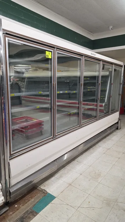 1988 Hussmann RFH-5LU frozen food glass doors. Features adjustable shelving, bottom wire racks, perforated back panels, and interior lighting. Electri