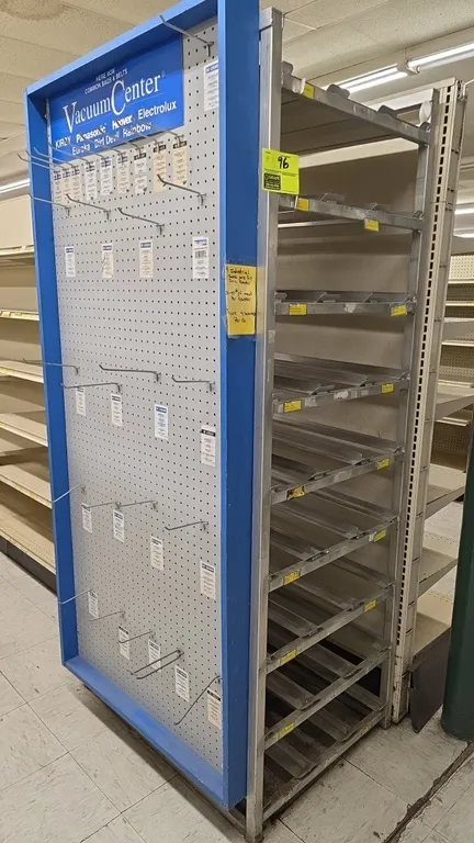 Aluminum can storage rack with attached side pegboard display. Features multi-tier can rack shelves, top solid shelf, and side pegboard with wire hook