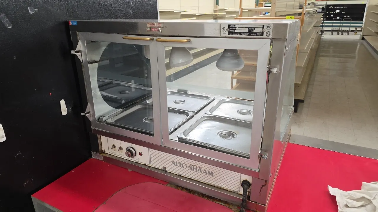 Alto-Shaam MCD-30 dry-heat countertop merchandising display case. Features stainless steel construction, glass display doors, overhead heat lamps, and