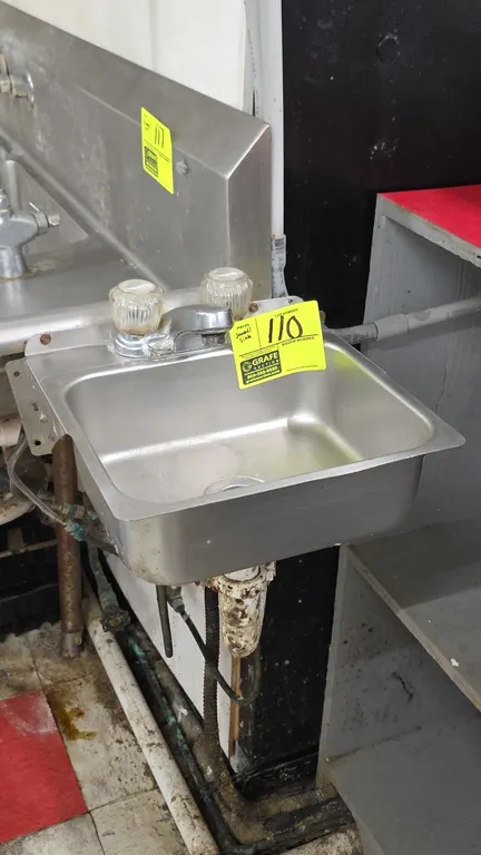 Stainless steel hand sink. Features a single-compartment basin, dual-handle faucet with clear acrylic knobs, and center drain. 13" x 13". Wall-mount c