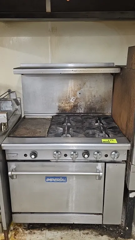 Imperial natural gas range. Features stainless steel construction, (4) open burners with cast iron grates, 12" x 24" griddle, lower oven with rack, an
