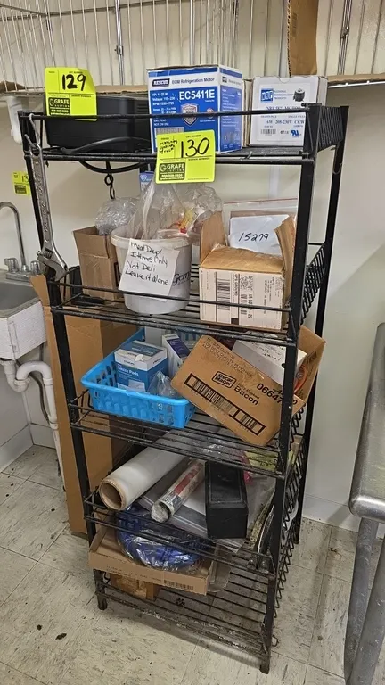 Metal 5-tier wire shelving rack with assorted contents. Includes refrigeration motors, valve repair kit, adjustable wrench, packaging supplies, and as