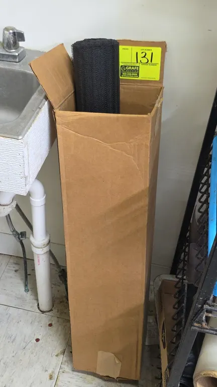 Black rubber mesh liner partial roll. Features non-slip textured mesh construction suitable for shelving or drawers. Includes cardboard storage box.
