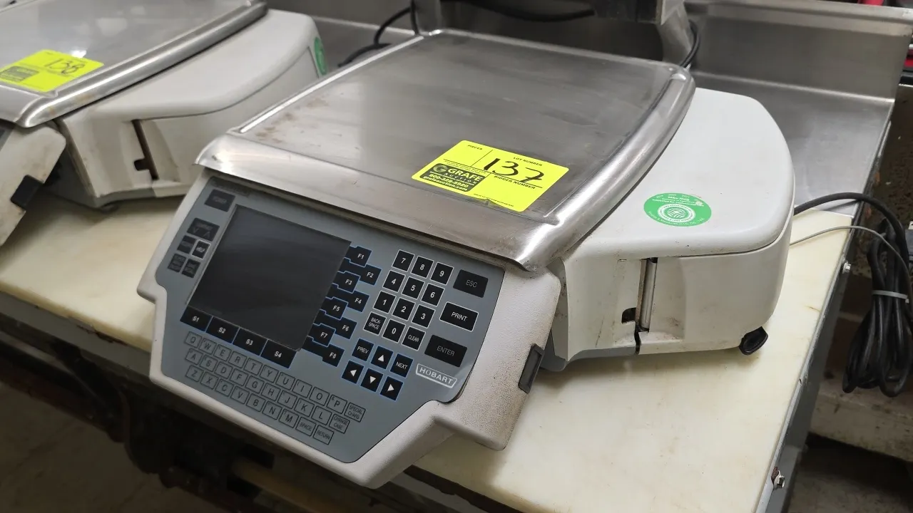 Hobart Quantum digital food scale with integrated label printer. Features stainless steel weighing platter, digital display screen, alphanumeric keypa