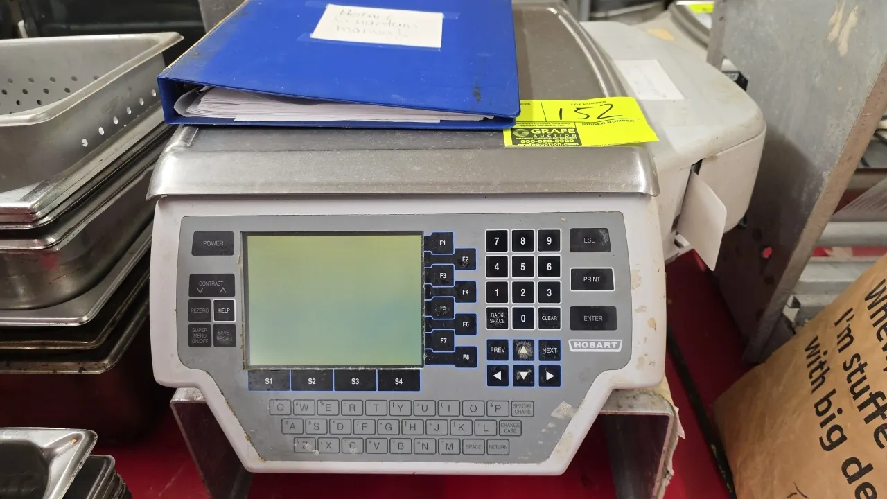 Hobart Quantum digital computing scale with integrated printer. Includes aluminum riser stand and manual binder. S/N: BU-1053-094. Electrical: 120V, 6