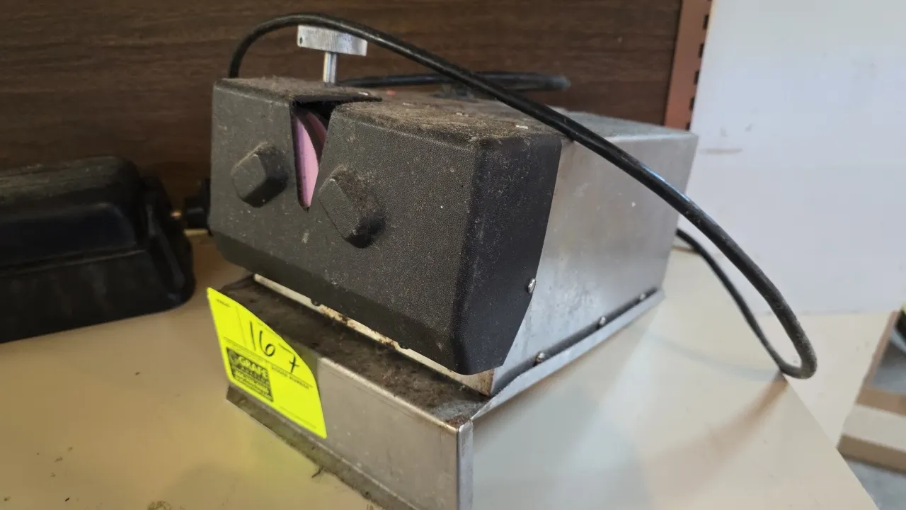 Tru-Hone LC electric knife sharpener. Features stainless steel housing, dual rotary honing wheels, and adjustable sharpening angle controls. Electrica