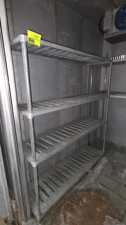 Metal 4-tier shelving rack. Features galvanized slotted shelves and tubular upright posts. Dimensions: 5' x 1'6" x 5'9".