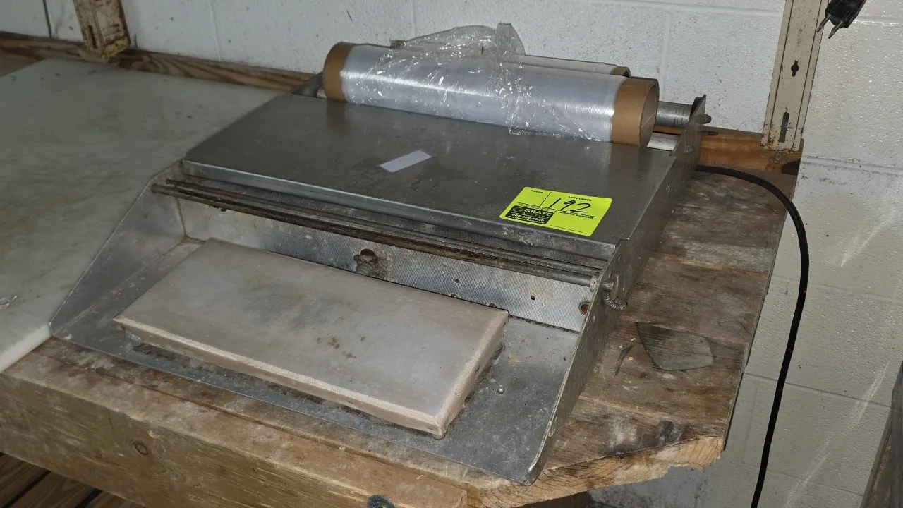 Heat Seal 24" dual roll film wrapper. Features stainless steel construction, dual roll capacity, front heat sealing hot plate, and cutoff bar. 24"W. T