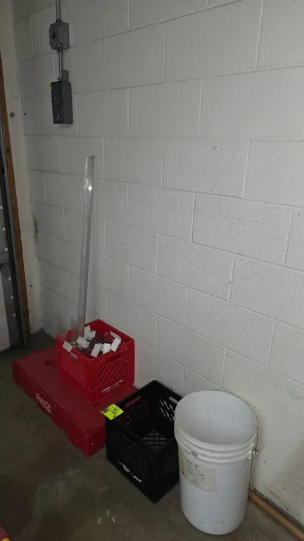 Assorted plastic and poly retail items. Includes a red Coca-Cola display base riser, (2) plastic milk crates, a 5-gallon plastic bucket, and assorted