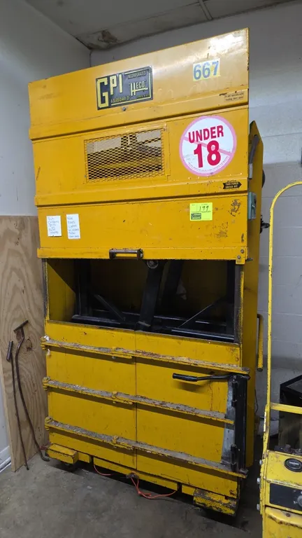 GPI 2242 D5AB portable vertical cardboard baler. Features top feed chamber with wire mesh viewing window, manual hydraulic lever control, front bale d