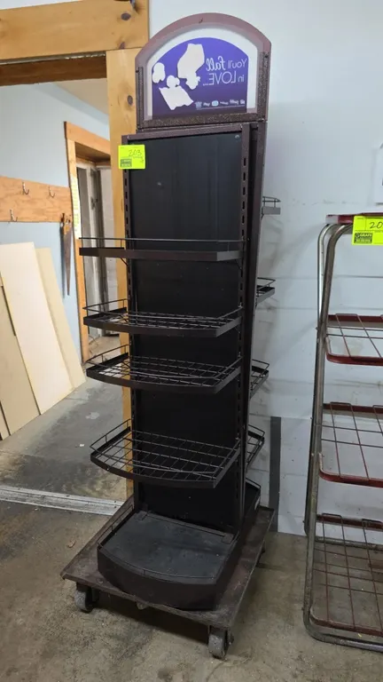 Metal 5-tier double-sided merchandiser display rack. Features adjustable wire shelves with front retaining lips, solid base decks, and top arched grap