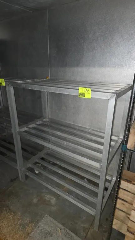 Aluminum 3-tier dunnage rack. Features welded tubular aluminum construction with 3 slatted shelf tiers. Dimensions: 4'L x 2'W x 5'H.