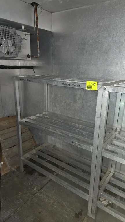 Aluminum 3-tier dunnage rack. Features welded tubular aluminum construction with 3 slatted shelf levels. Dimensions: 4' x 2' x 5'. Adjacent rack and s