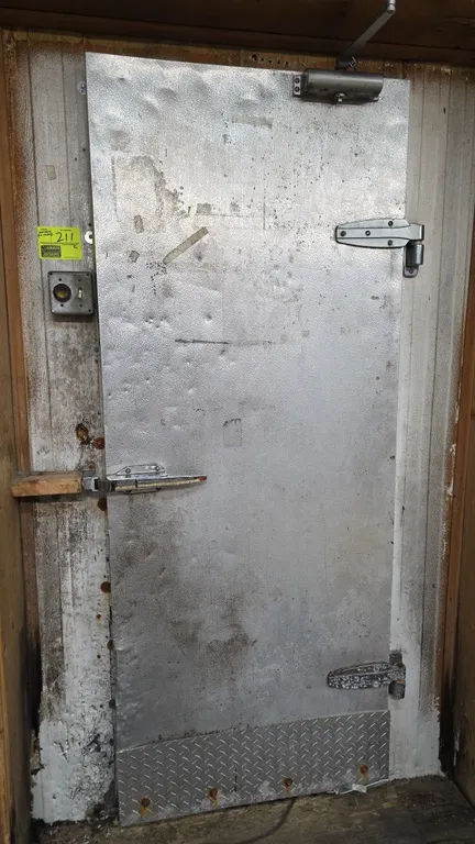 International Cold Storage SP1F-828 walk-in cooler. Features a 32" x 79" entry door, vinyl strip curtains, and (2) Russell 3-fan evaporator coils. S/N