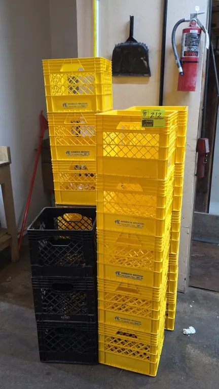 Polyethylene milk crates. Includes (19) stackable crates in yellow and black featuring Anderson Erickson and Kemps dairy markings. Constructed with la