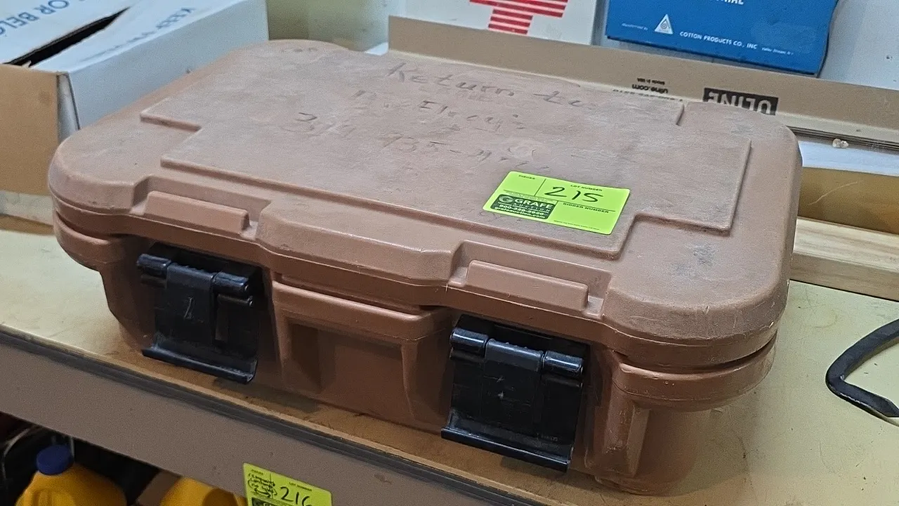Cambro insulated cooler. Features brown molded polyethylene construction, hinged lid, and dual front latches. 24"L. Note: Writing on lid.