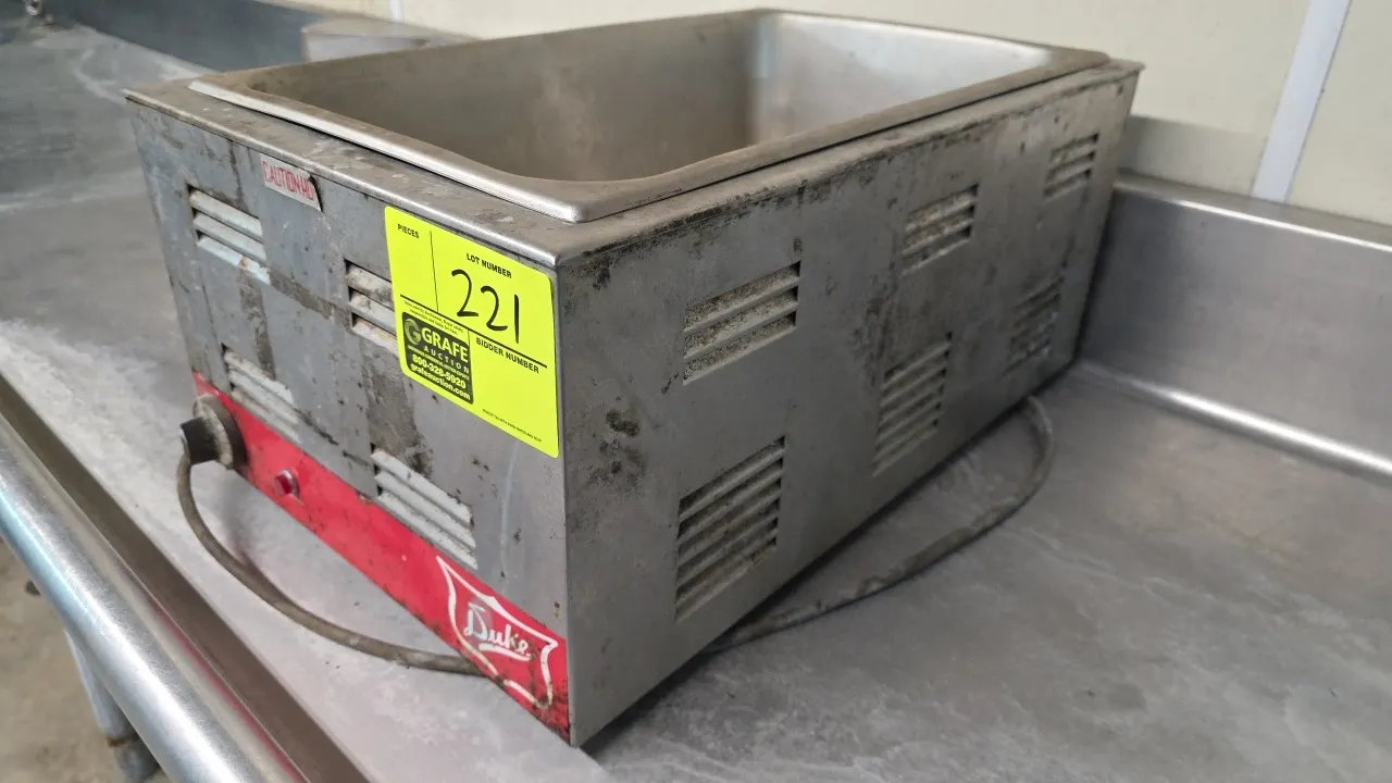 Duke full-size countertop food warmer. Features stainless steel housing, analog dial temperature control, indicator light, and louvered side ventilati