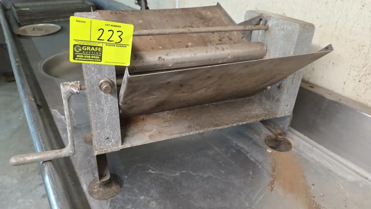 Moyer Diebel PM-2 countertop manual dough sheeter. Features manual hand crank operation, stainless steel rollers, and dual feed and discharge chutes.