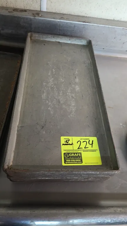 Commercial sheet pans and bake pans. Features metal construction with raised edges. 10.75" x 22" (sheet pans).