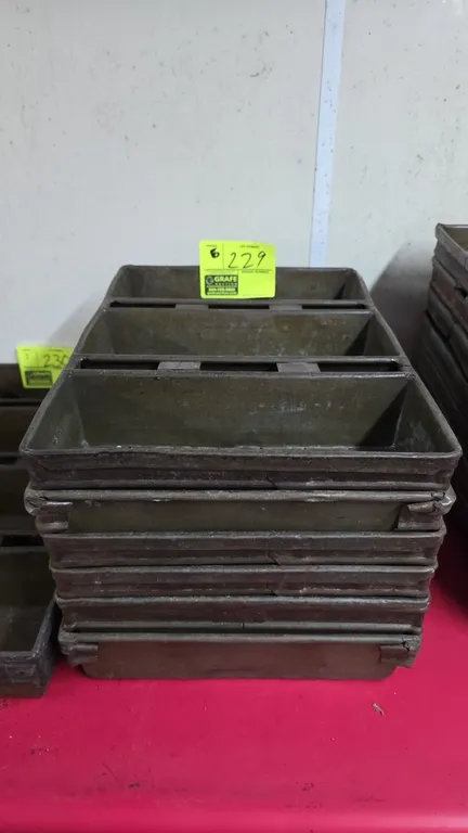 Metal strapped multi-loaf pans. Features 3-loaf strapped configuration with perforated bottoms. Measures 12.5" x 17.5".