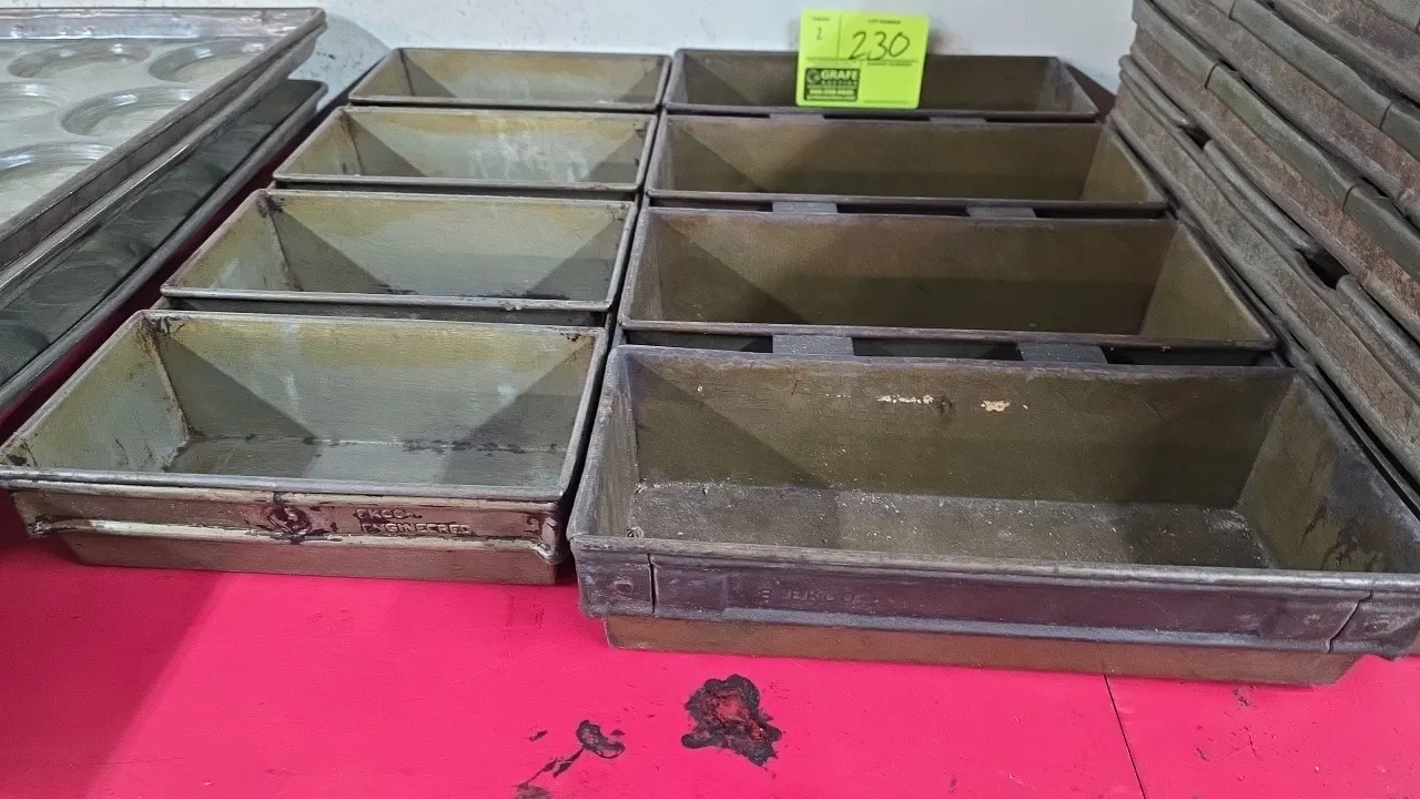 Ekco and assorted metal strapped multi-loaf pans. Each features a 4-loaf configuration with connecting side straps. Includes (1) 9.5" x 22" pan set an