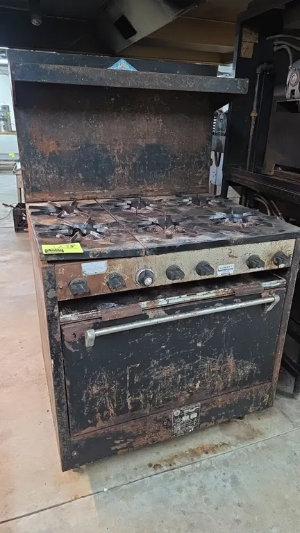 Comstock-Castle C330 6-burner gas range. Features six open burners with cast iron grates, lower standard oven, and a backguard with high shelf. Fueled
