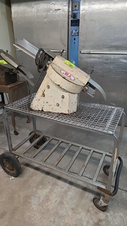 U.S. Slicing Machine Company RS bun slicer with cart. Features adjustable chute and 1/4 HP motor. S/N: RS-2728. Electrical: 115V, 60 Hz, 1-Phase, 5.0
