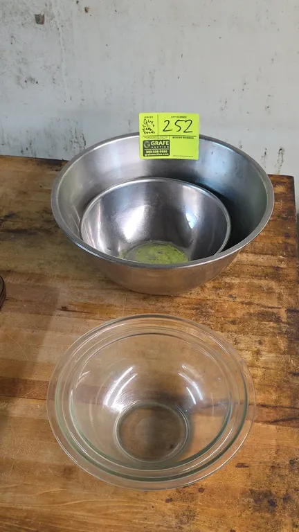 Assorted stainless steel and glass mixing bowls. Includes (2) nested stainless steel mixing bowls and (2) nested clear glass mixing bowls.