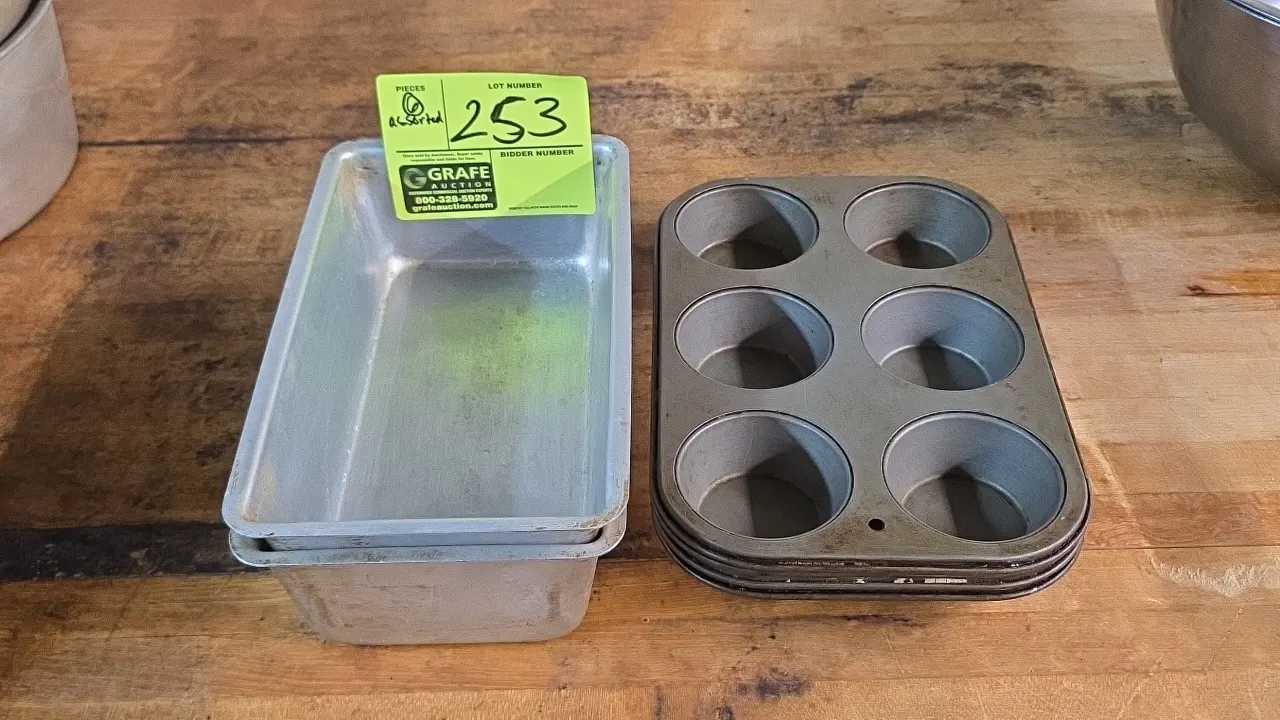 Assortment of (6) baking pans. Includes (2) aluminum loaf pans and (4) 6-cup muffin pans.