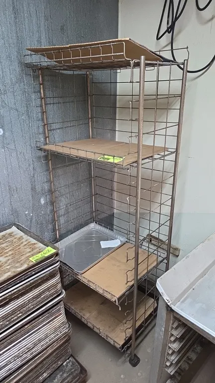 Metal 4-tier mobile wire rack. Features adjustable wire shelves. Mounted on casters. Note: Trays and dolly not included.