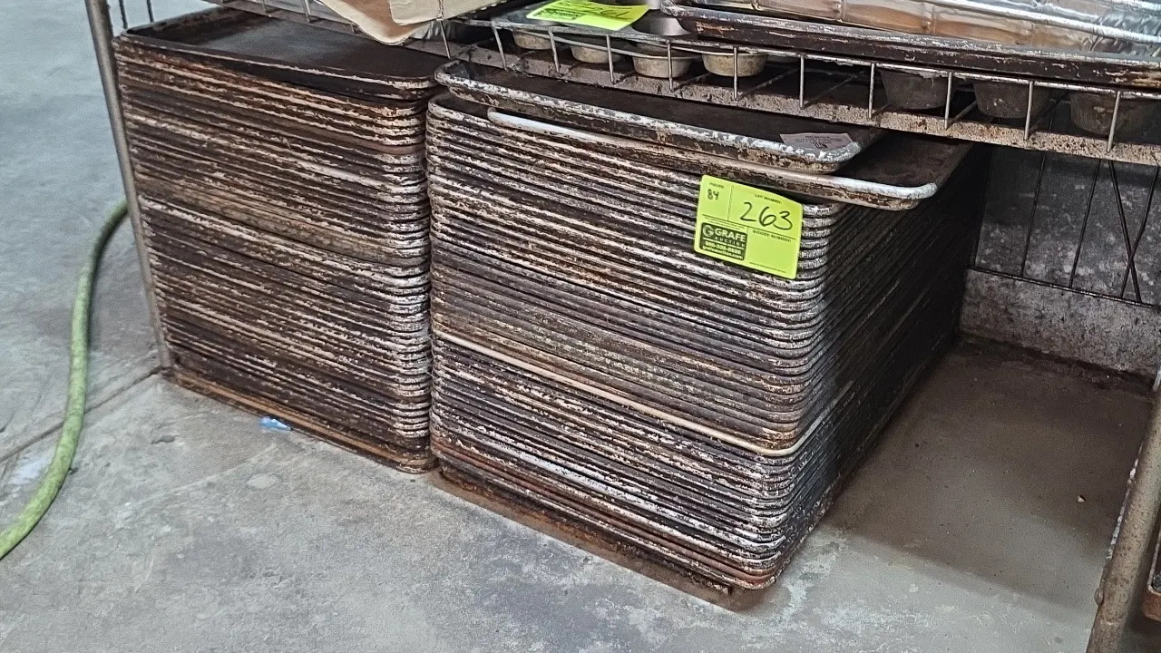 Full-size aluminum sheet pans. Features rimmed edges. Wire shelving and surrounding items not included.