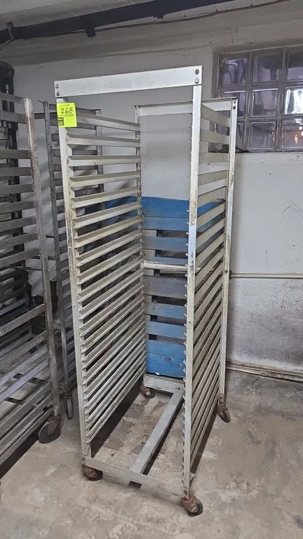 Aluminum portable front-load sheet pan rack. Features 20-tier pan slides and aluminum frame construction. Mounted on swivel casters.