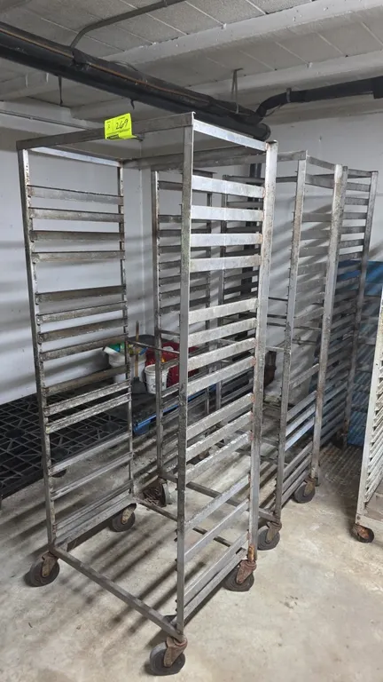 Stainless steel portable side-load sheet pan racks. Features angle pan slides. Mounted on swivel casters.