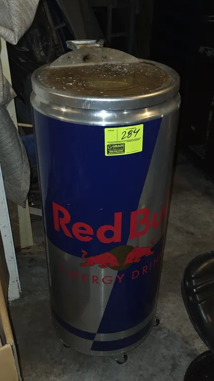Red Bull portable refrigerated can cooler. Features Red Bull graphic exterior styled as an energy drink can, transparent flip-top lid, interior compar