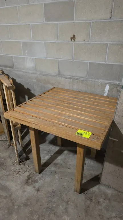 Wood produce display table. Features a slatted wood top and solid wood legs. Measures 3' x 3'.