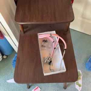 Closet Contents Including Table, Pink Stethoscope, Water Bottle, Hangers, and Bags