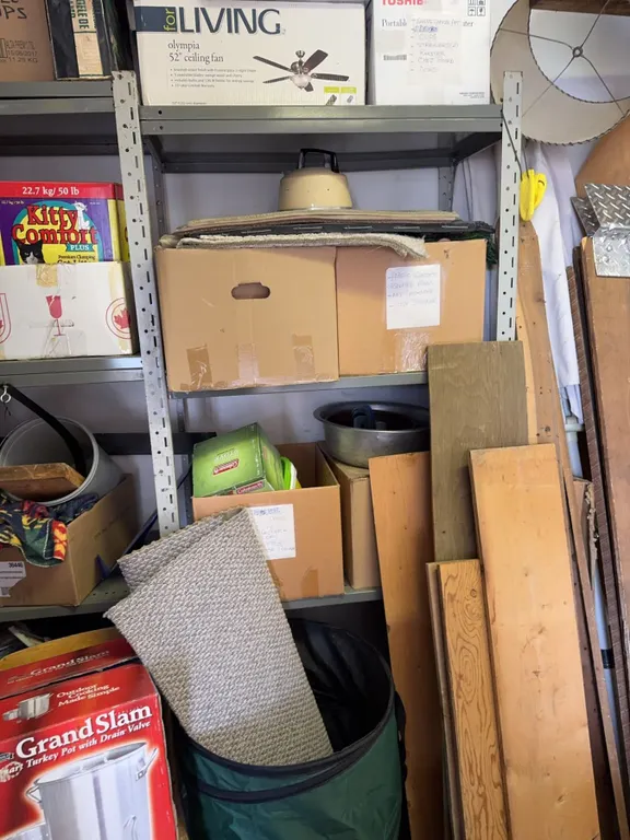 Two Metal Storage Racks With All Contents Included: Boxes, Wood Planks, Household Items